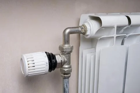 Temperature control knob on room battery. Regulation of heating power in the  Stock Photos