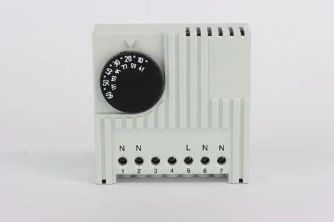 A temperature controller on a din rail for controlling fans. Stock Photos