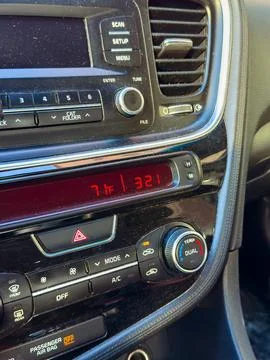Temperature display shows 7 degrees Fahrenheit while driving in a car on an.. Stock Photos