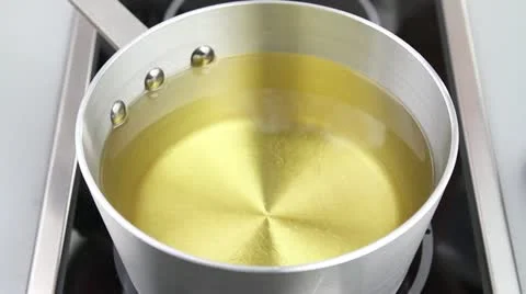 The temperature of frying fat being checked (wooden stick test) Stock-Footage 24647294