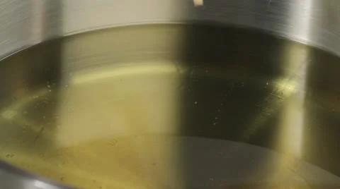 The temperature of frying fat being checked (wooden stick test) Stock-Footage 24666167