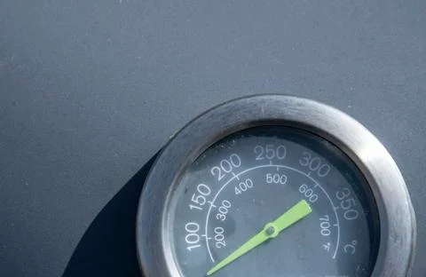Temperature indicator with green pointer on a grill Stock Photos