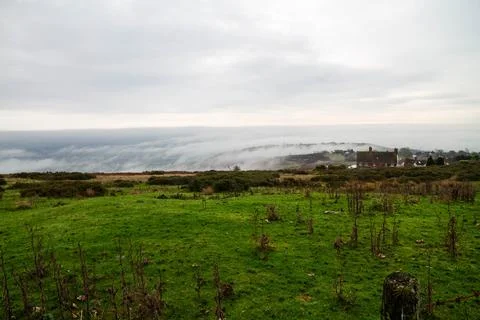 Temperature Inversion with clouds hugging valleys and hills. Stock Photos