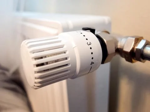 Temperature knob of heating radiator Stock Photos