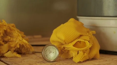 Temperature meter with a pile of wax behind it Video stock 74057407