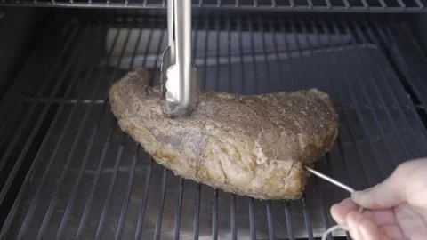Temperature probe placed into brisket steak Stock Footage 244272560
