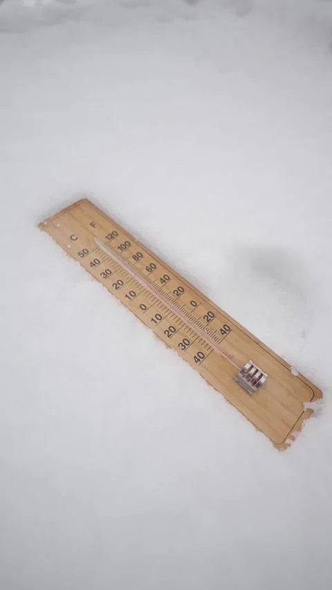Temperature reading on a thermometer placed in the snow during winter Stock Footage 346513638