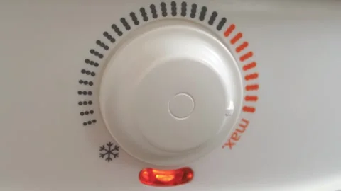 Temperature regulator for heating cold water in boiler. Red indicator went out Stock Footage 317853234