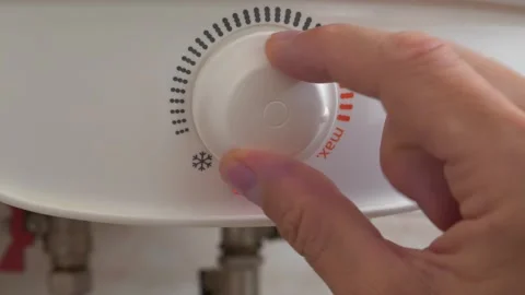 Temperature regulator for heating cold water in boiler. Red indicator went out Stock Footage 321195082