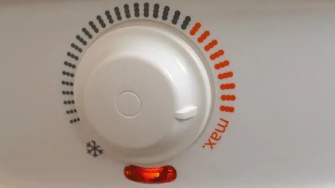 Temperature regulator for heating cold water in boiler. Red indicator went out Stock Footage 323867389