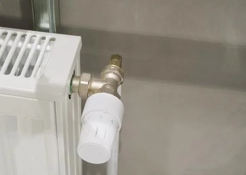 Temperature regulator of heating system in a private house. Stock Photos