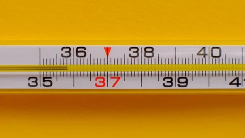 Temperature rising shown on a thermometer on a yellow background close-up. Stock Footage 119074631