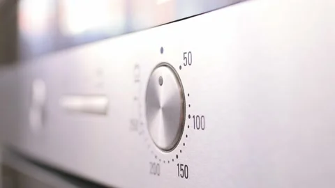 Temperature switch on electric oven. Setting modes for cooking food. Concept of Stock Footage 217954208