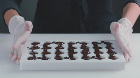 Tempered chocolate in Mold. Slow motion. Confectionery Video stock 69055405