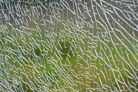 Tempered glass full of tiny cracks holding together in close detail. Stock Photos