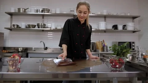 Tempering of the chocolate on the metal surface. Production of chocolates. Stock Footage 136833901