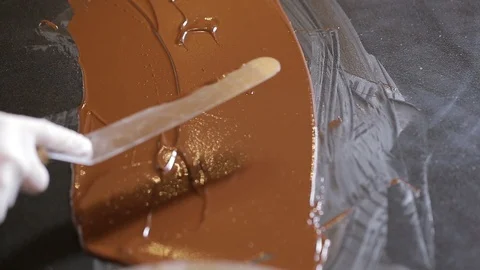 Tempering chocolate temperature for using a marble Stock Footage 94229324