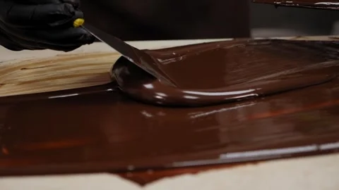Tempering of the chocolate on the wooden surface. Stock Footage 270061440