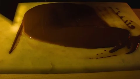 Tempering melted chocolate on table Видео 79862612