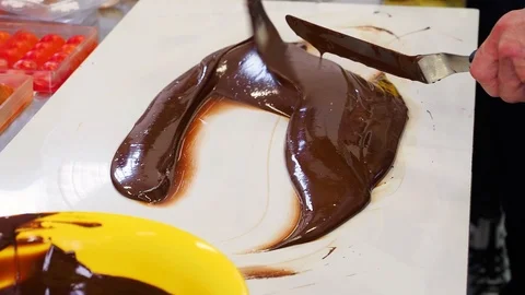 Tempering melted chocolate on table Stock Footage 127291557