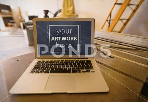 Template of laptop on wooden table PSD Template
