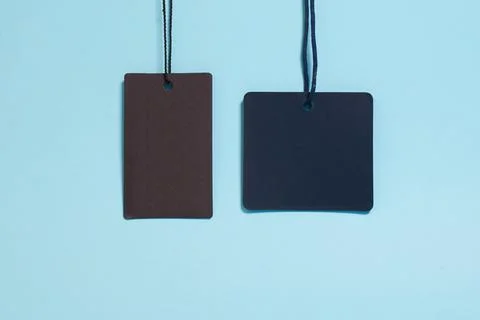 Template. Two empty tags for clothes and shoes on a blue background Stock Photos