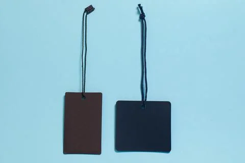 Template. Two empty tags for clothes and shoes on a blue background Stock Photos