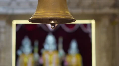 Temple Bell with Blurred Hindu Deities in Background Stock Footage 336884685