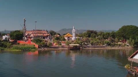 Temple complex and statue along the River Kwai in Kanchanaburi Thailand 库存影片 330450815