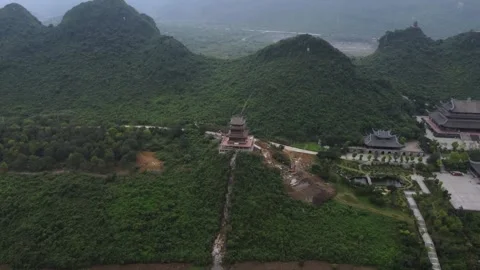 Temple complex, pagodas next to forest and mountains Video stock 242094388