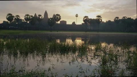 Temple complex silhouette with reflections in a pond at sunrise Stock Footage 305646098