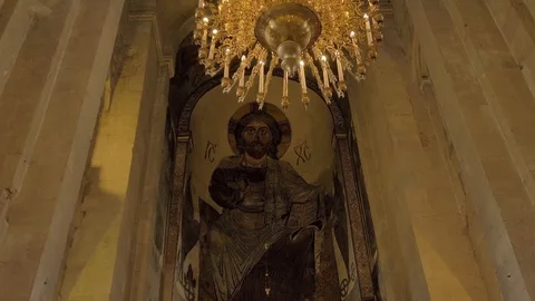 Temple is from inside with a large chandelier and a picture of Christian god. Stock Footage 111383375