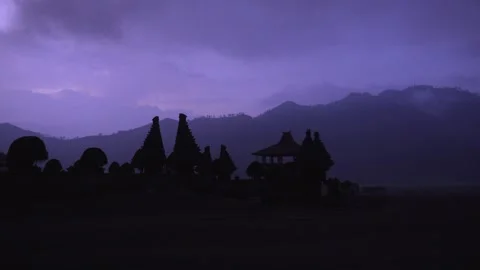 Temple pagoda shadow highlights Mount Bromo active volcano Java island 스톡 동영상 312426141