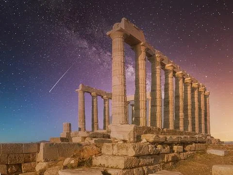 Temple of Poseidon in Greece against a dramatic night sky. Stock Photos