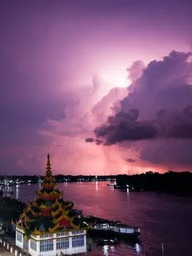 A temple on the riverside with storm clouds in the sky Stock Photos