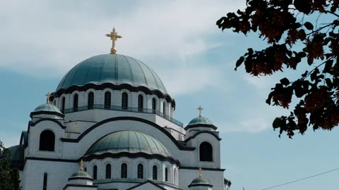 The Temple of Saint Sava in Belgrade framed by autumn leaves. The largest Stock Footage 316596916