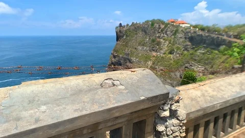 The temple, standing on the edge of a cliff and powerful waves of the blue ocean Stock Footage 122125745