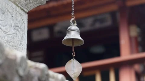 Temple Wind Chime Swaying Beneath Eaves in Yunnan Stock Footage 312449560