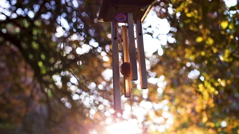 A temple wind chime sways in slow motion against a golden sunset Video stock 141581007