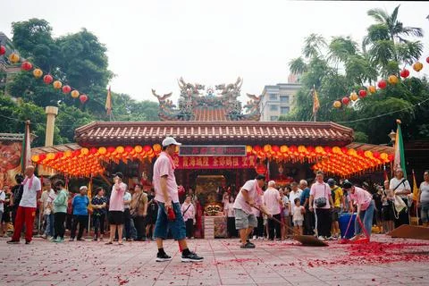Temple worker sweeping firecracker debris after parade in Taipei 写真素材