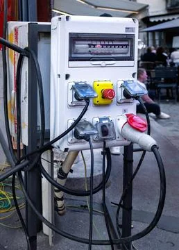 Temporary electric distribution box with cables on a city street counter Stock Photos