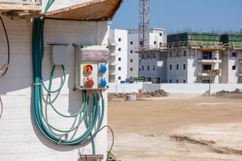 Temporary electrical distribution box mounted on building wall at construct.. Stock Photos