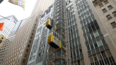 Temporary elevator outside building under construction on Manhattan Stock Footage 99390906