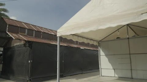 Temporary event tent structures in an industrial yard Stock-Footage 335732226
