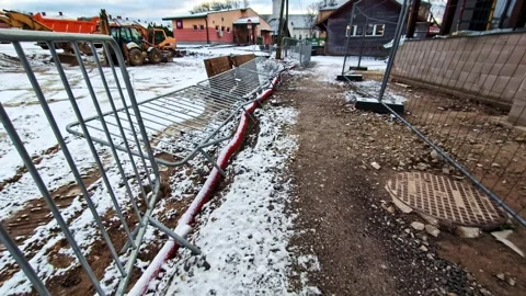 Temporary fencing securing a construction site during groundwork, covered in Stock Footage 328090157