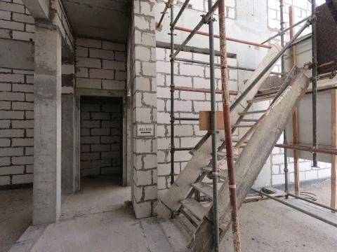 Temporary Ladder going up at a Construction Site of a modern house on a plot  Stockfoto's
