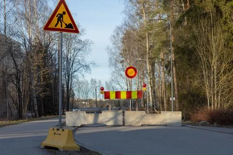 A temporary road closure barrier, featuring substantial concrete blocks and a 스톡 사진