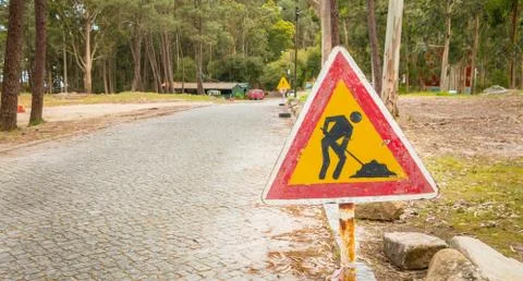 Temporary road sign indicating work on a small road in the forest Stock Photos