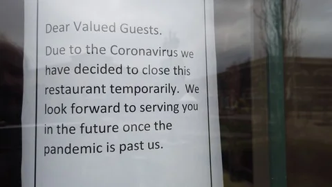 Temporary sign restaurant door closed coronavirus pandemic Stock Footage