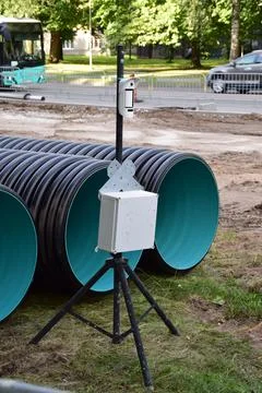 Temporary Site Surveillance Camera Stand Near Corrugated Plastic Pipes Stock Photos